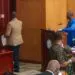 Senator McGill in brown jacket and blue jeans leaving the chamber