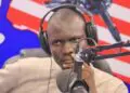 man sitting behind a microphone