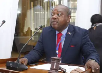 LNBA president speaks into a microphone with a gavel on his desk