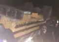 Overturned passenger bus at night after fatal crash near Gbarkor Hill, Bong County, Liberia