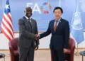 FAO Director-General Qu Dongyu and Liberia’s Agriculture Minister J. Alexandar Nuetah shake hands at the launch of the Liberia Situation Room in Rome