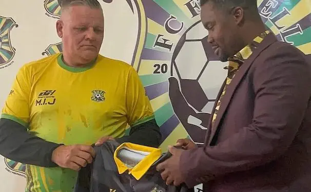 FC Fassell official presents club jersey to Belgian coach Ivan Minnaert during his unveiling ceremony in Monrovia before their contract dispute.