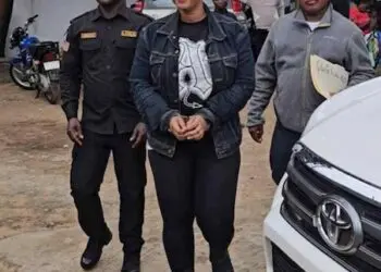 LDEA officers escort Liberian businesswoman Quita Dolo Kosso in handcuffs after her arrest for trafficking US$181K worth of cocaine from Bangkok at Roberts International Airport