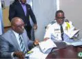 Inspector General Gregory Coleman and AME University President Rev. Dr. Alvin E. Attah sign an MOU to enhance police training and academic collaboration in Liberia.