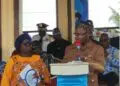 Margibi County Superintendent Ojay Morris delivers his speech at the UN@80 celebration in Kakata as President Joseph N. Boakai and UN officials look on
