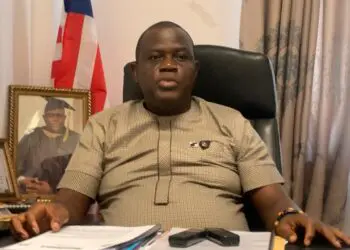Grand Bassa County Representative Matthew Joe seated at his desk during budget discussion.