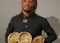 Liberian artist King Dennis holding multiple MLMA 2025 award trophies after winning major categories.