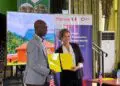 A Liberian official and a French Development Agency representative hold signed cooperation documents during the launch of the €9M WISE forest conservation initiative.