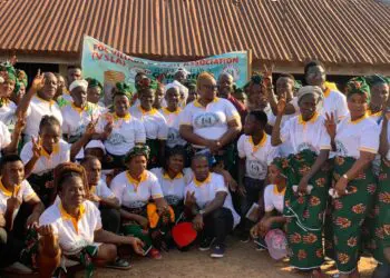 A large group of women from the Friends of Collins Village Savings Association in Borlia, Gbarpolu County, pose together during their 2024–2025 graduation ceremony after achieving an L$8 million savings milestone