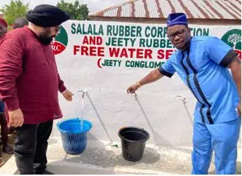 Jeety Rubber and Salala Rubber Corporation officials, including Margibi Superintendent O. Jay Morris, test a newly dedicated free borehole tap providing clean drinking water in Weala, Margibi County.