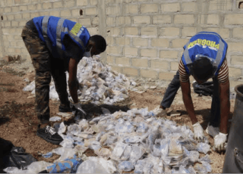 Youth volunteers sort collected plastic waste for recycling in Gbarnga, Bong County.