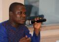 CENTAL head Anderson Miamen speaking into a microphone