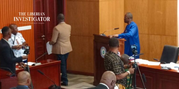 Senator McGill in brown jacket and blue jeans leaving the chamber
