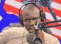 man sitting behind a microphone