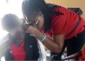 a woman testing another woman's hearing