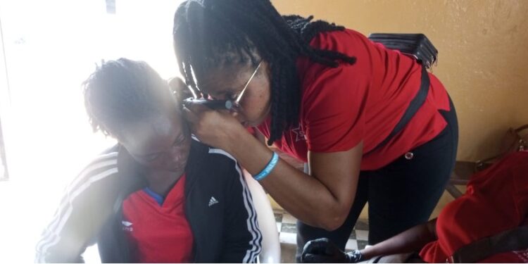a woman testing another woman's hearing