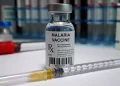 a vaccine bottle with syringe