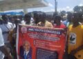 Young members of the ANC Youth Congress hold a banner during a youth leadership retreat in Monrovia, Liberia, promoting the theme “Empowering Youth Leadership for Liberia’s Transformative Development,” with a photo of ANC political leader Alexander B. Cummings