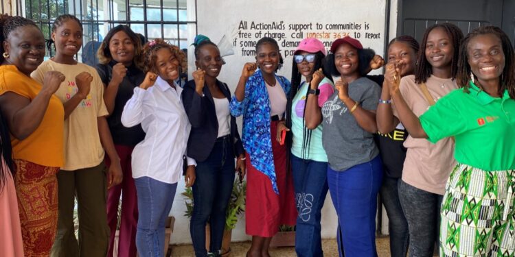 ActionAid Liberia Country Director, Madam Lakshmi Subramani (right), poses with members of the Young Feminist Movement during a menstrual health campaign in Monrovia.