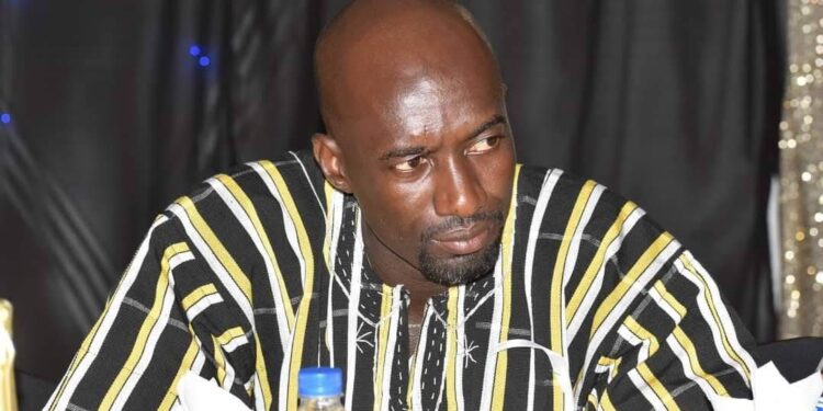 striped traditional African shirt sits at a table