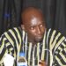 striped traditional African shirt sits at a table