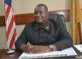 Former Senate Pro Tempore Armah Zolu Jallah sitting at his office desk