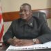 Former Senate Pro Tempore Armah Zolu Jallah sitting at his office desk