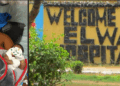 Split image showing (left) a young Liberian mother, Jamesetta Kugmeh, lying in a hospital bed with an oxygen mask and holding her newborn baby after undergoing emergency treatment at ELWA Hospital; and (right) the front entrance sign of ELWA Hospital in Monrovia, Liberia, reading “WELCOME TO ELWA HOSPITAL