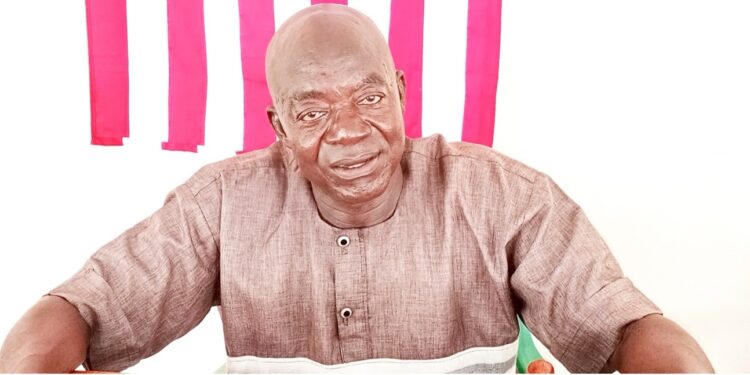 Gbor District Commissioner Ernest W. Doitoe Sr. at his desk during interview about ongoing infrastructure project