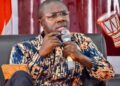 Jefferson T. Koijee former Mayor of Monrovia speaking in a microphone