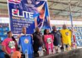 Officials from the Jordan Nwora Foundation and Liberia Basketball Association pose with branded shirts at the launch of the 2025 youth basketball camp in Monrovia.