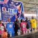 Officials from the Jordan Nwora Foundation and Liberia Basketball Association pose with branded shirts at the launch of the 2025 youth basketball camp in Monrovia.