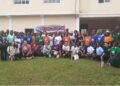Group photo of 47 Gbarnga schoolgirls, American youth missionaries, and organizers during a workshop by Kathy Justice Girls Educational Liberia on teen pregnancy and drug abuse prevention.