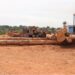 Timber logs stacked at Krish Veneer Industries’ yard in Buchanan, Grand Bassa County, Liberia, where Vice President Jeremiah Koung dedicated the controversial sawmill in 2025.