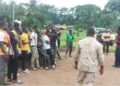 Liberia Immigration Service officers conducting a registration session with Burkinabé nationals in a rural area during the national migrant documentation campaign.