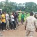 Liberia Immigration Service officers conducting a registration session with Burkinabé nationals in a rural area during the national migrant documentation campaign.