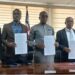 Government officials hold signed MOU documents during the launch of Liberia’s first National Digital Health Insurance Pilot for vulnerable citizens.