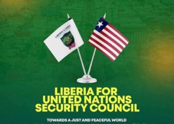 Campaign banner showing Liberia’s flag and the UN Security Council flag side-by-side, promoting the country’s 2026–2027 UNSC bid with the slogan “Towards a Just and Peaceful World.”
