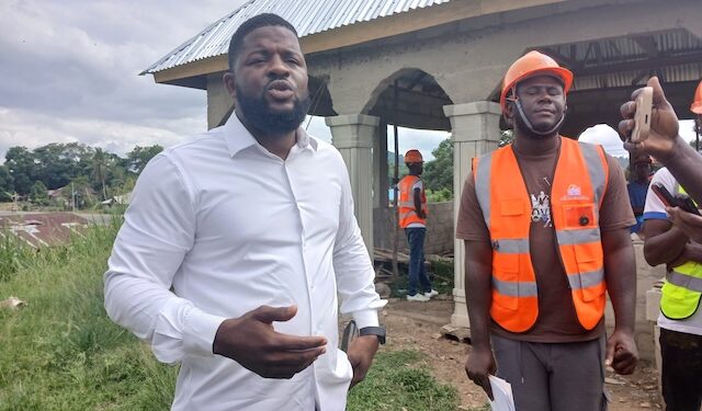Rep. Moima Briggs Mensah’s Chief of Office Staff, Murfee Anderson, defends a legislative development project in Salala, Bong County, during a site visit with contractors and staff.