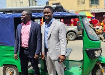NEEV Liberia officials pose beside one of their newly launched electric tricycles in Monrovia, part of the company’s e-mobility drive toward sustainable transportation.