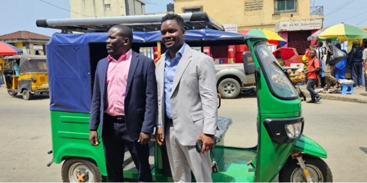 NEEV Liberia officials pose beside one of their newly launched electric tricycles in Monrovia, part of the company’s e-mobility drive toward sustainable transportation.