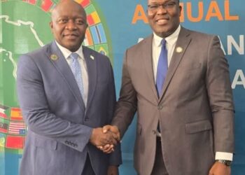 Liberian Finance Minister Augustine Ngafuan shakes hands with outgoing AfDB Constituency 15 Executive Director Rufus N. Darkortey during the 2025 Annual Meetings in Abidjan.