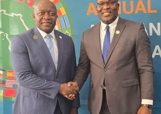 Liberian Finance Minister Augustine Ngafuan shakes hands with outgoing AfDB Constituency 15 Executive Director Rufus N. Darkortey during the 2025 Annual Meetings in Abidjan.