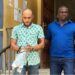 Peach Bility, escorted in handcuffs by a court officer, exits Criminal Court “C” in Monrovia following a pretrial hearing on drug and firearm charges.