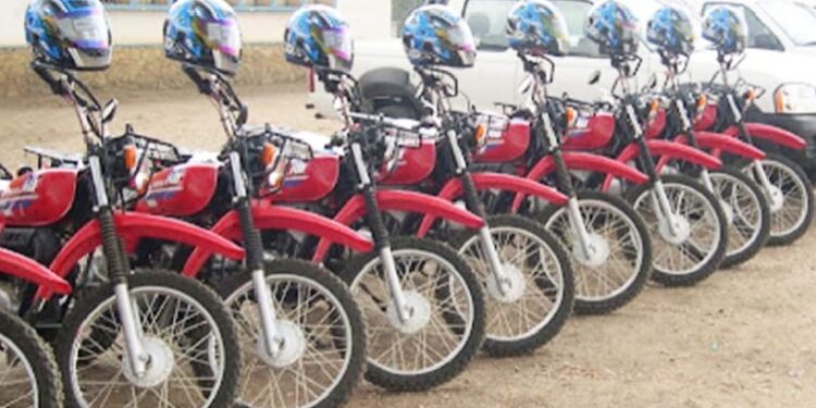 Lineup of red Yamaha motorbikes with helmets donated by Plan International Liberia to Maryland County health authorities to support rural healthcare delivery