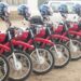 Lineup of red Yamaha motorbikes with helmets donated by Plan International Liberia to Maryland County health authorities to support rural healthcare delivery