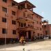 Front view of Prince Y. Johnson Polyethnic University in Ganta, Liberia, with students and motorcycles gathered outside during closure