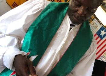 Rev. Lemeo G. Ivy, the 49-year-old pastor charged with negligent homicide, reads from the Bible before his arrest in Harper, Maryland County.