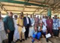 Representative Romeo Quioh (standing third from the left) poses for a picture with an African Finch Logging Limited executive, and townspeople of Numopoh. Picture credit: Anonymous