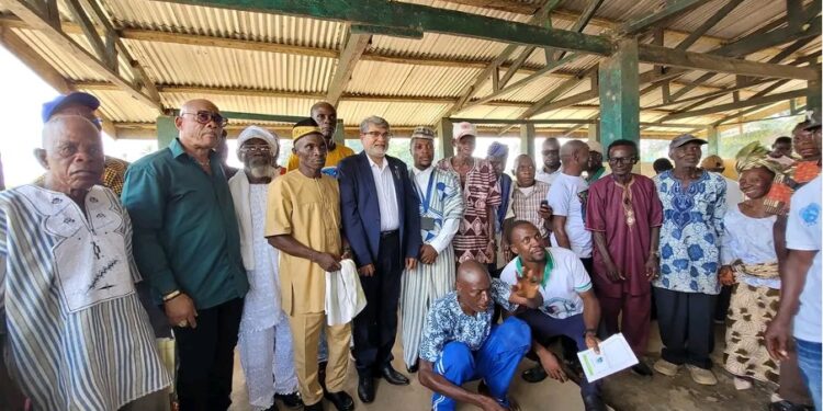 Representative Romeo Quioh (standing third from the left) poses for a picture with an African Finch Logging Limited executive, and townspeople of Numopoh. Picture credit: Anonymous